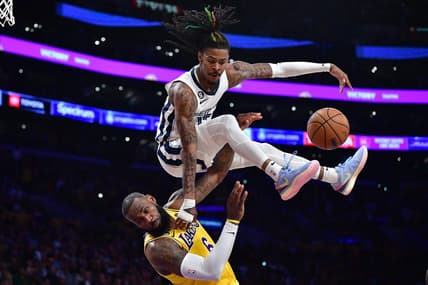 Apr 24, 2023; Los Angeles, California, USA; Memphis Grizzlies guard Ja Morant (12) collides with Los Angeles Lakers forward LeBron James (6) while moving to the basket during the second half in game four of the 2023 NBA playoffs at Crypto.com Arena. Mandatory Credit: Gary A. Vasquez-USA TODAY Sports