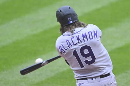 Apr 25, 2023; Cleveland, Ohio, USA; Colorado Rockies right fielder Charlie Blackmon (19) hits an RBI double during the second inning against the Cleveland Guardians at Progressive Field. Mandatory Credit: David Richard-USA TODAY Sports