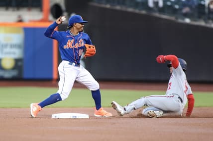 Apr 26, 2023; New York City, New York, USA; New York Mets shortstop Francisco Lindor (12) throws to first base over Washington Nationals left fielder Alex Call (17) while attempting to complete a double play in the first inning at Citi Field. Mandatory Credit: Wendell Cruz-USA TODAY Sports