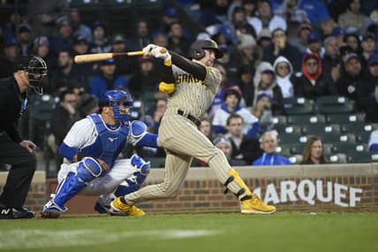 Apr 26, 2023; Chicago, Illinois, USA;  San Diego Padres first baseman Jake Cronenworth (9) hits an RBI triple against the Chicago Cubs during the fourth inning at Wrigley Field. Mandatory Credit: Matt Marton-USA TODAY Sports