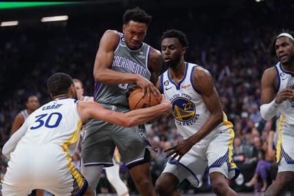 Apr 26, 2023; Sacramento, California, USA; Sacramento Kings guard Malik Monk (0) holds onto the ball next to Golden State Warriors guard Stephen Curry (30) and forward Andrew Wiggins (22) in the second quarter during game five of the 2023 NBA playoffs at the Golden 1 Center. Mandatory Credit: Cary Edmondson-USA TODAY Sports