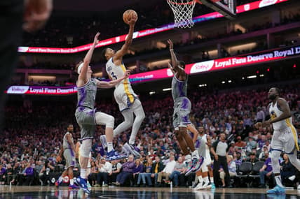 Apr 26, 2023; Sacramento, California, USA; Golden State Warriors guard Jordan Poole (3) makes a basket between Sacramento Kings guard Kevin Huerter (9) and guard De'Aaron Fox (5) in the third quarter during game five of the 2023 NBA playoffs at the Golden 1 Center. Mandatory Credit: Cary Edmondson-USA TODAY Sports