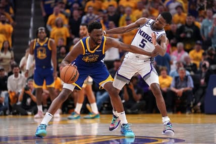 Apr 28, 2023; San Francisco, California, USA; Golden State Warriors forward Andrew Wiggins (22) dribbles the ball next to Sacramento Kings guard De'Aaron Fox (5) in the third quarter during game six of the 2023 NBA playoffs at the Chase Center. Mandatory Credit: Cary Edmondson-USA TODAY Sports