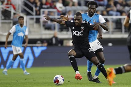 Apr 29, 2023; Washington, District of Columbia, USA; D.C. United forward Christian Benteke (20) and Charlotte FC midfielder Derrick Jones (20) battle for the ball in the first half at Audi Field. Mandatory Credit: Geoff Burke-USA TODAY Sports