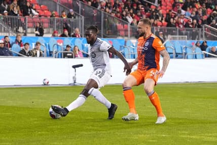 Apr 29, 2023; Toronto, Ontario, CAN; New York City FC defender Maxime Chanot (4) fights for ball possession against Toronto FC forward Charles Sapong (9) during the first half at BMO Field. Mandatory Credit: Nick Turchiaro-USA TODAY Sports