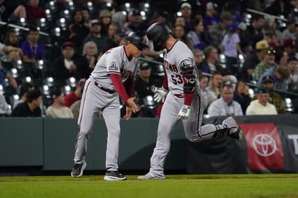 Apr 29, 2023; Denver, Colorado, USA;  Arizona Diamondbacks first baseman Christian Walker (53) hits a solo home run in the top of the ninth inning at Coors Field. Walker gets a low five from Arizona Diamondbacks third base coach Tony Perezchica (21). Mandatory Credit: Michael Madrid-USA TODAY Sports
