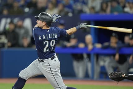 Apr 30, 2023; Toronto, Ontario, CAN; Seattle Mariners catcher Cal Raleigh (29) hits a two run home run against the Toronto Blue Jays during the tenth inning at Rogers Centre. Mandatory Credit: John E. Sokolowski-USA TODAY Sports