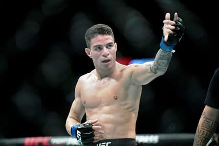 Jul 20, 2019; San Antonio, TX, USA; Felipe Colares (blue gloves) after his win over Domingo Pilarte (not pictured) during UFC Fight Night at AT&T Center. Colares won the fight. Mandatory Credit: Adam Hagy-USA TODAY Sports
