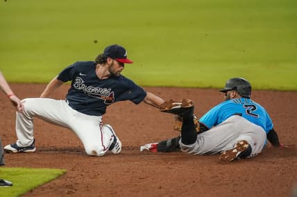 Jul 21, 2020; Cumberland, Georgia, USA; Miami Marlins second baseman Jonathan Villar (2) steals second base behind Atlanta Braves shortstop Charlie Culberson (8) during the sixth inning at Truist Park. Mandatory Credit: Dale Zanine-USA TODAY Sports