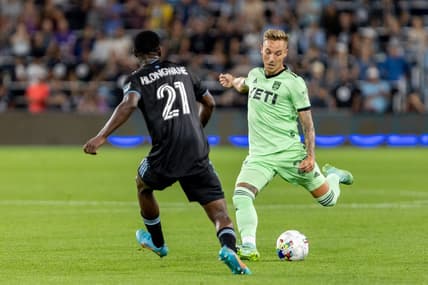 Aug 20, 2022; Saint Paul, Minnesota, USA; Austin FC defender Zan Kolmanic (23) passes in front of Minnesota United forward Bongokuhle Hlongwane (21) meet at Allianz Field. Mandatory Credit: Matt Blewett-USA TODAY Sports