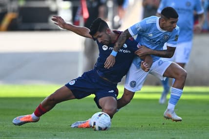 Aug 21, 2022; Chicago, Illinois, USA;  Chicago Fire FC defender Mauricio Pineda (22) is pulled down by New York City FC midfielder Santiago Rodriguez (20) in the first half at Bridgeview Stadium. Mandatory Credit: Jamie Sabau-USA TODAY Sports