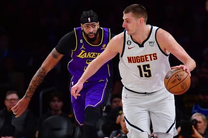 Dec 16, 2022; Los Angeles, California, USA; Denver Nuggets center Nikola Jokic (15) moves the ball ahead of Los Angeles Lakers forward Anthony Davis (3)  during the first half at Crypto.com Arena. Mandatory Credit: Gary A. Vasquez-USA TODAY Sports