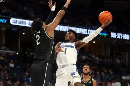 Feb 16, 2023; Memphis, Tennessee, USA; Memphis Tigers guard Keonte Kennedy (1) shoots as UCF Knights forward Michael Durr (2) defends during the first half at FedExForum. Mandatory Credit: Petre Thomas-USA TODAY Sports