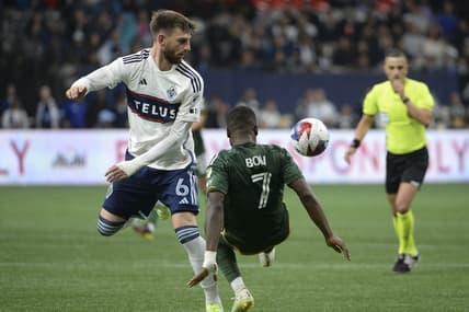 Apr 8, 2023; Vancouver, British Columbia, CAN;  Vancouver Whitecaps FC defender Tristan Blackmon (6) battles for the ball against Portland Timbers forward Franck Boli (7) during the second half at BC Place. Mandatory Credit: Anne-Marie Sorvin-USA TODAY Sports
