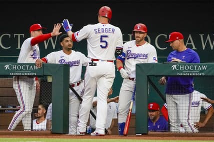 Apr 10, 2023; Arlington, Texas, USA; Texas Rangers shortstop Corey Seager (5) is greeted at the dugout after hitting a solo home run during the first inning against the Kansas City Royals at Globe Life Field. Mandatory Credit: Raymond Carlin III-USA TODAY Sports