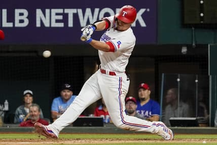 Apr 10, 2023; Arlington, Texas, USA;  Texas Rangers shortstop Corey Seager (5) hits a single during the eighth inning against the Kansas City Royals at Globe Life Field. Mandatory Credit: Raymond Carlin III-USA TODAY Sports