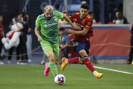 Apr 29, 2023; Sandy, Utah, USA; Seattle Sounders forward Jordan Morris (13) and Real Salt Lake defender Brayan Vera (4) battle in the first half at America First Field. Mandatory Credit: Jeffrey Swinger-USA TODAY Sports