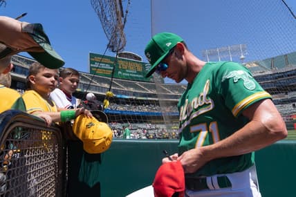 Apr 30, 2023; Oakland, California, USA;  Oakland Athletics bullpen coach Mike McCarthy (71) signs autographs for fans before the start of the first inning against the Cincinnati Reds at RingCentral Coliseum. Mandatory Credit: Stan Szeto-USA TODAY Sports
