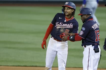 May 2, 2023; Washington, District of Columbia, USA; Washington Nationals shortstop CJ Abrams (5) celebrates with Nationals first base coach Eric Young Jr. (12) after hitting and RBI single against the Chicago Cubs during the seventh inning at Nationals Park. Mandatory Credit: Geoff Burke-USA TODAY Sports