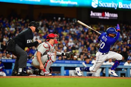 May 2, 2023; Los Angeles, California, USA; Los Angeles Dodgers right fielder Mookie Betts (50) hits a two run RBI single against the Philadelphia Phillies during the second inning at Dodger Stadium. Mandatory Credit: Gary A. Vasquez-USA TODAY Sports
