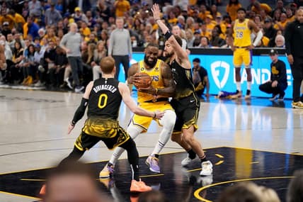May 2, 2023; San Francisco, California, USA; Los Angeles Lakers forward LeBron James (6) drives to the hoop between Golden State Warriors guard Donte DiVincenzo (0) and guard Klay Thompson (11) in the second quarter during game one of the 2023 NBA playoffs at the Chase Center. Mandatory Credit: Cary Edmondson-USA TODAY Sports