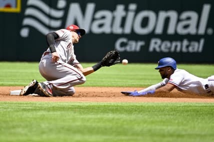 May 3, 2023; Arlington, Texas, USA; Arizona Diamondbacks shortstop Nick Ahmed (13) tags out Texas Rangers center fielder Leody Taveras (3) on a steal attempt during the second inning at Globe Life Field. Mandatory Credit: Jerome Miron-USA TODAY Sports