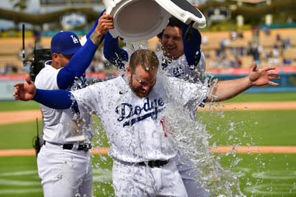 May 3, 2023; Los Angeles, California, USA; Los Angeles Dodgers left fielder David Peralta (6) and center fielder James Outman (33) pour water on third baseman Max Muncy (13) after he his a walk off grand slam home run against the Philadelphia Phillies at Dodger Stadium. Mandatory Credit: Gary A. Vasquez-USA TODAY Sports