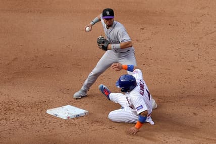May 6, 2023; New York City, New York, USA; Colorado Rockies shortstop Ezequiel Tovar (14) forces out New York Mets catcher Francisco Alvarez (4) at second base on a ground ball by Mets center fielder Brandon Nimmo (not pictured) during the fifth inning at Citi Field. Mandatory Credit: Brad Penner-USA TODAY Sports