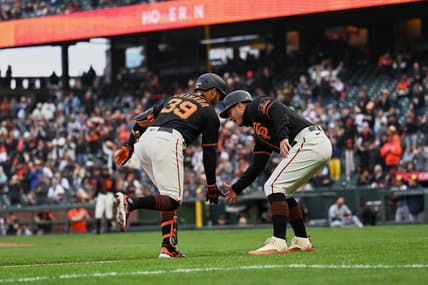 May 6, 2023; San Francisco, California, USA; San Francisco Giants infielder Thairo Estrada (39) shakes hands with third base coach Mark Hallberg (91) after hitting a two-run home run against the Milwaukee Brewers during the third inning at Oracle Park. Mandatory Credit: Robert Edwards-USA TODAY Sports