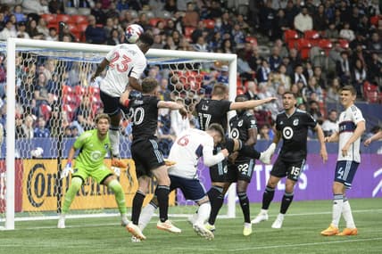 May 6, 2023; Vancouver, British Columbia, CAN;  Vancouver Whitecaps FC defender Javain Brown (23) heads the ball towards the net of Minnesota United FC goalkeeper Dayne St. Clair (97) during the first half at BC Place.  Mandatory Credit: Anne-Marie Sorvin-USA TODAY Sports