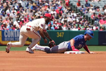 May 7, 2023; Anaheim, California, USA; Texas Rangers right fielder Robbie Grossman (4) slides beneath the tag of Los Angeles Angels second baseman Luis Rengifo (2) into second base in the first inning at Angel Stadium. Mandatory Credit: Kirby Lee-USA TODAY Sports