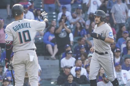May 7, 2023; Chicago, Illinois, USA; Miami Marlins pinch-runner Garrett Hampson (1) scores on a balk and is greeted by first baseman Yuli Gurriel (10) against the Chicago Cubs during the fourteenth inning at Wrigley Field. Mandatory Credit: David Banks-USA TODAY Sports