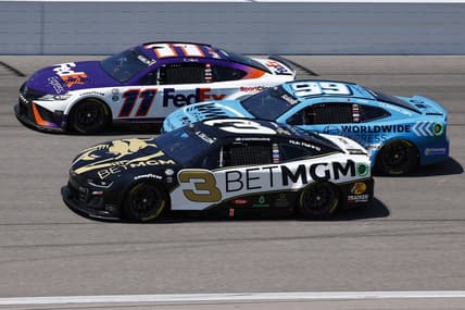 May 7, 2023; Kansas City, Kansas, USA; NASCAR Cup Series driver Denny Hamlin (11), driver Austin Dillon (3) and  driver Daniel Suarez (99) race three wide during the AdventHealth 400 at Kansas Speedway. Mandatory Credit: Mike Dinovo-USA TODAY Sports
