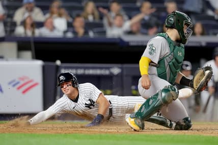 May 9, 2023; Bronx, New York, USA; New York Yankees shortstop Anthony Volpe (11) scores against Oakland Athletics catcher Shea Langeliers (23) on a sacrifice fly by Yankees right fielder Aaron Judge (not pictured) during the eighth inning at Yankee Stadium. Mandatory Credit: Brad Penner-USA TODAY Sports