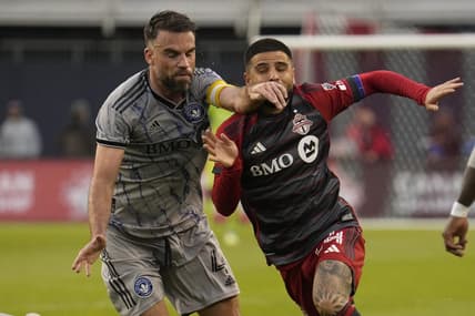 May 9, 2023; Toronto, Ontario, CAN; CF Montreal defender Rudy Camacho (4) and Toronto FC forward Lorenzo Insigne (24) battle for position during the first half at BMO Field. Mandatory Credit: John E. Sokolowski-USA TODAY Sports