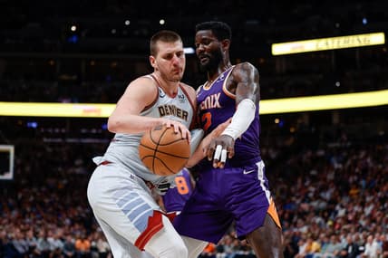 May 9, 2023; Denver, Colorado, USA; Denver Nuggets center Nikola Jokic (15) controls the ball as Phoenix Suns center Deandre Ayton (22) defends in the fourth quarter during game five of the 2023 NBA playoffs at Ball Arena. Mandatory Credit: Isaiah J. Downing-USA TODAY Sports
