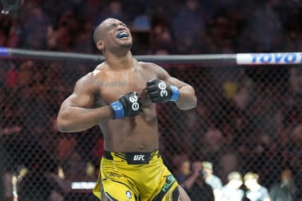 May 13, 2023; Charlotte, North Carolina, USA; Jailton Almeida (blue gloves) reacts after defeating Jairzinho Rozenstruik (red gloves) in a heavyweight bout during UFC Fight Night at Spectrum Center. Mandatory Credit: Jim Dedmon-USA TODAY Sports