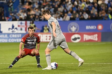 May 13, 2023; Montreal, Quebec, CAN; CF Montreal midfielder Lassi Lappalainen (21) controls the ball defended by Toronto FC midfielder Kobe Franklin (19) in the second half at Stade Saputo. Mandatory Credit: David Kirouac-USA TODAY Sports