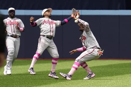 May 14, 2023; Toronto, Ontario, CAN; Atlanta Braves second baseman Ozzie Albies (center) and right fielder Ronald Acuna Jr. (right) drop the ball as they collide while attempting to catch a ball hit by Toronto Blue Jays left fielder Whit Merrifield (not pictured) during the second inning at Rogers Centre. Mandatory Credit: John E. Sokolowski-USA TODAY Sports