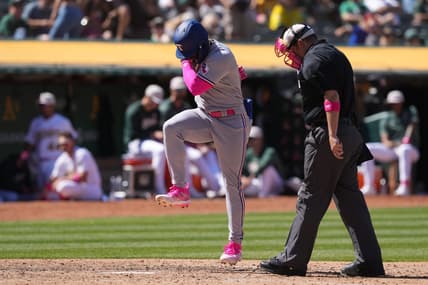 May 14, 2023; Oakland, California, USA; Texas Rangers right fielder Adolis Garcia (center) steps on home plate after hitting a grand slam home run against the Oakland Athletics as home plate umpire Dan Bellino (right) watches during the eighth inning at Oakland-Alameda County Coliseum. Mandatory Credit: Darren Yamashita-USA TODAY Sports