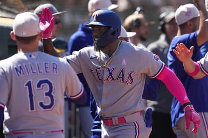 May 14, 2023; Oakland, California, USA; Texas Rangers right fielder Adolis Garcia (center) celebrates with teammates after hitting a grand slam home run against the Oakland Athletics during the eighth inning at Oakland-Alameda County Coliseum. Mandatory Credit: Darren Yamashita-USA TODAY Sports