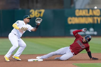 May 16, 2023; Oakland, California, USA; Arizona Diamondbacks second baseman Ketel Marte (4) slides into second base during the fifth inning against Oakland Athletics second baseman Jordan Diaz (13) at Oakland-Alameda County Coliseum. Mandatory Credit: Stan Szeto-USA TODAY Sports
