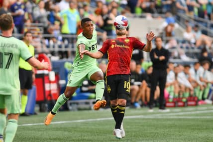 May 17, 2023; Seattle, Washington, USA; Austin FC midfielder Jhojan Valencia (5) and Seattle Sounders midfielder Nicolas Lodeiro (10) both jump for the ball during the first half at Lumen Field. Mandatory Credit: Steven Bisig-USA TODAY Sports