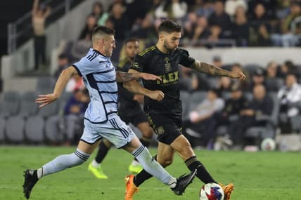 May 17, 2023; Los Angeles, California, USA; Los Angeles FC midfielder Ryan Hollingshead (24) and Sporting Kansas City midfielder Remi Walter (54) fight for the ball during the second half at BMO Stadium. Mandatory Credit: Kiyoshi Mio-USA TODAY Sports