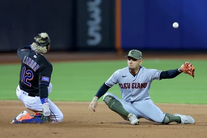 May 19, 2023; New York City, New York, USA; New York Mets shortstop Francisco Lindor (12) slides safely into second base for a double as the throw from the outfield gets away from Cleveland Guardians second baseman Andres Gimenez (0) during the fifth inning at Citi Field. Mandatory Credit: Brad Penner-USA TODAY Sports