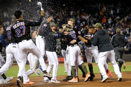 May 19, 2023; New York City, New York, USA; New York Mets shortstop Francisco Lindor (12) celebrates his walkoff RBI single against the Cleveland Guardians with teammates at Citi Field. Mandatory Credit: Brad Penner-USA TODAY Sports