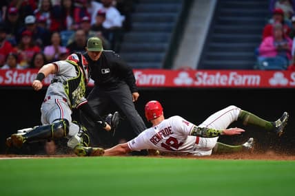 May 19, 2023; Anaheim, California, USA; Los Angeles Angels right fielder Hunter Renfroe (12) scores a run ahead of Minnesota Twins catcher Ryan Jeffers (27) during the fourth inning at Angel Stadium. Mandatory Credit: Gary A. Vasquez-USA TODAY Sports