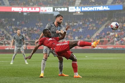 May 20, 2023; Harrison, New Jersey, USA; New York Red Bulls midfielder Dru Yearwood (16) kicks the ball while defended by CF Montreal defender Rudy Camacho (4) during the first half at Red Bull Arena. Mandatory Credit: Vincent Carchietta-USA TODAY Sports