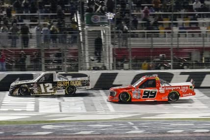 May 26, 2023; Concord, North Carolina, USA;  NASCAR Craftsman Truck Series driver Ben Rhodes (99) takes the checkered flag during the North Carolina Education Lottery 200 at Charlotte Motor Speedway. Mandatory Credit: Jim Dedmon-USA TODAY Sports