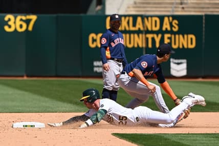 May 27, 2023; Oakland, California, USA; Oakland Athletics catcher Shea Langeliers (23) slides into second base against Houston Astros infielder Jose Altuve (27) during the eighth inning at Oakland-Alameda County Coliseum. Mandatory Credit: Robert Edwards-USA TODAY Sports
